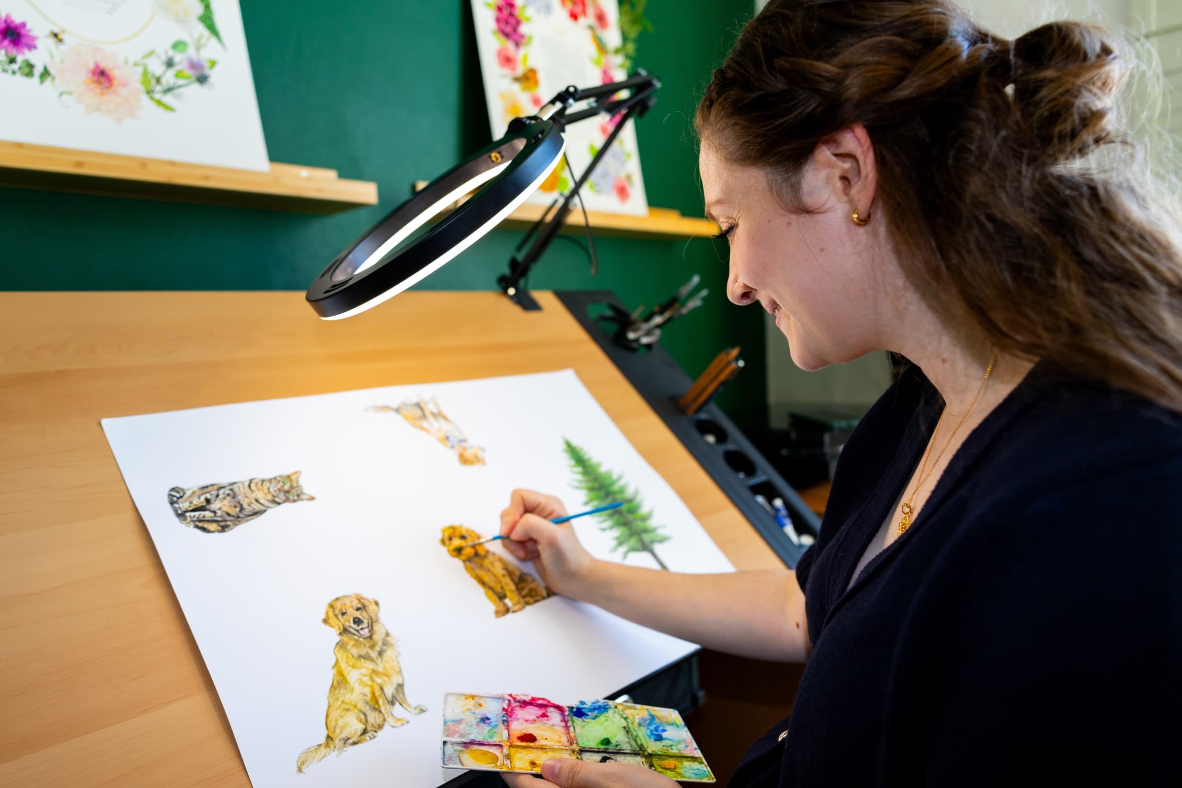 Sophie Bacall painting the Cockapoo and other original animal and foliage artwork for Ketubah Studio