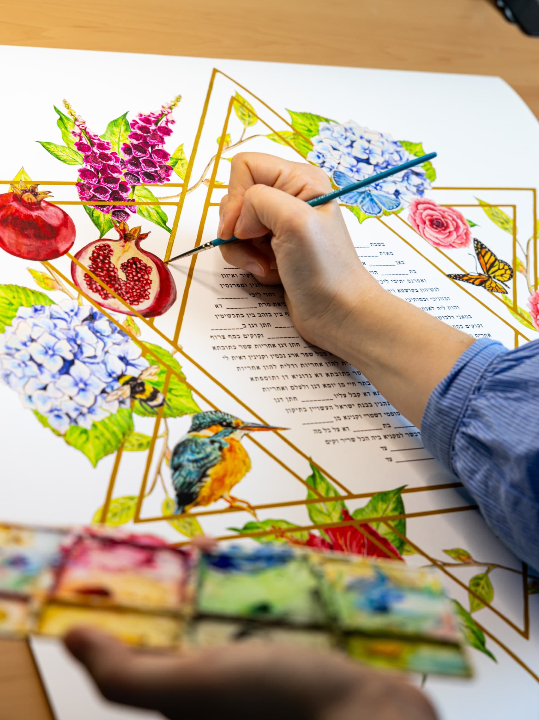 Sophie Bacall hand-painting the original artwork for a floral ketubah design