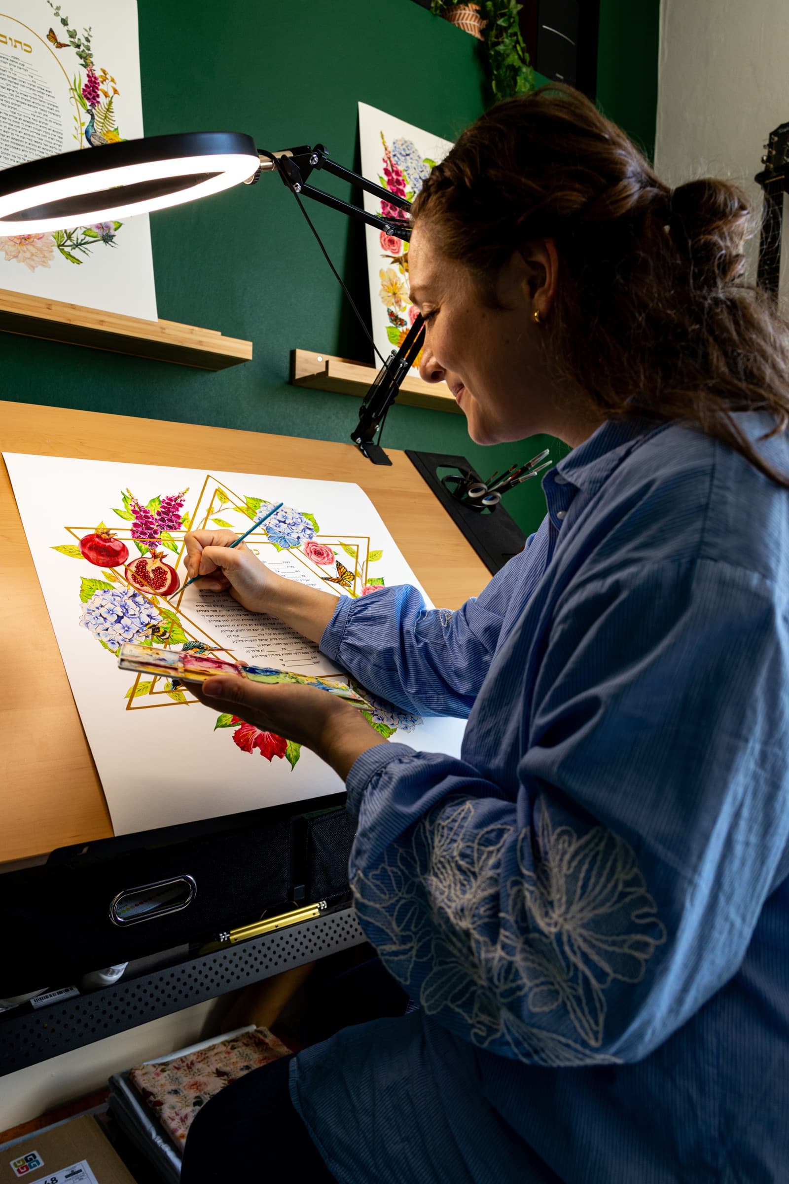 Sophie Bacall painting a custom ketubah by hand in her Manchester studio
