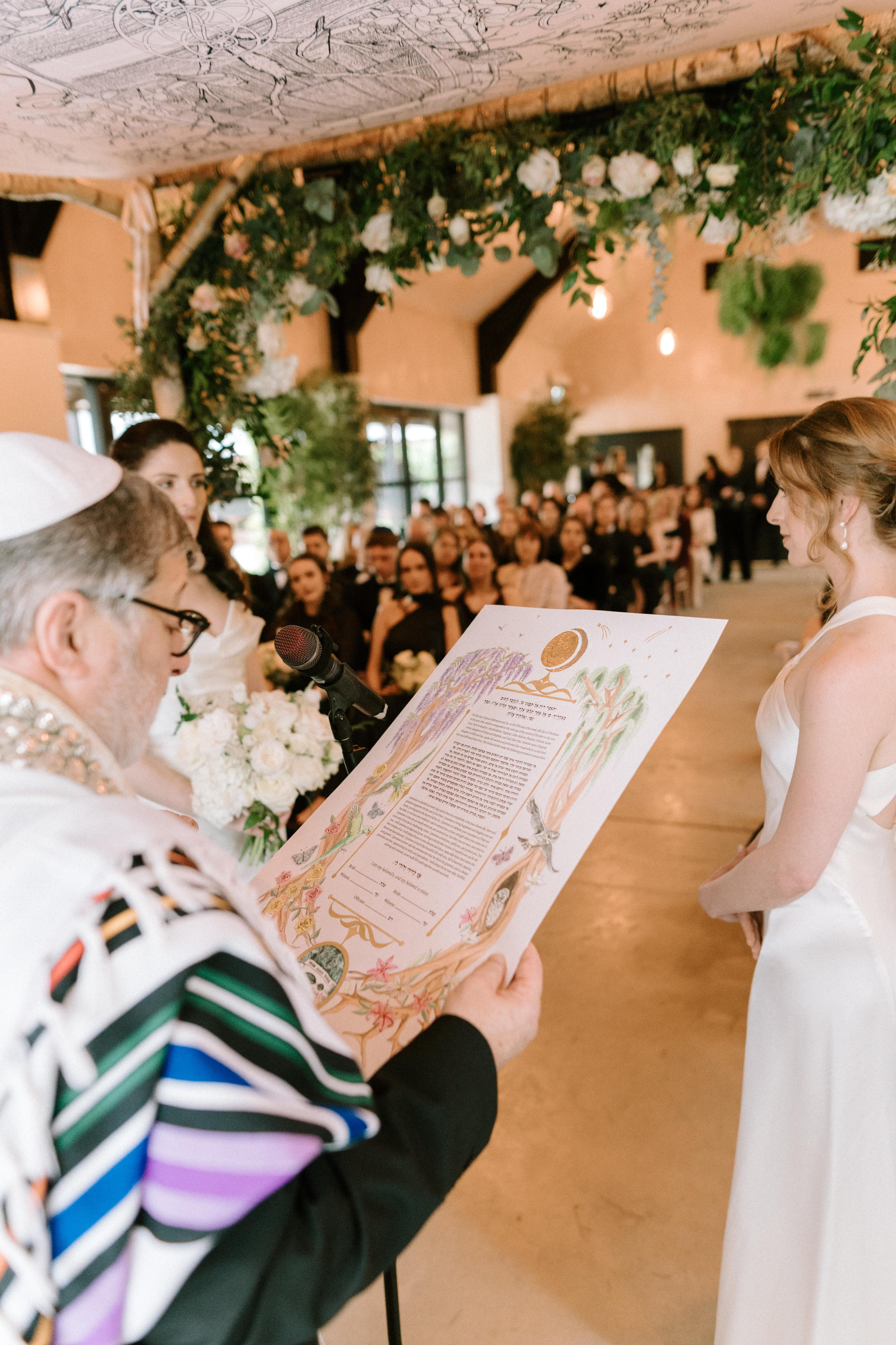 Chloe and Jade’s custom ketubah being read during their wedding ceremony